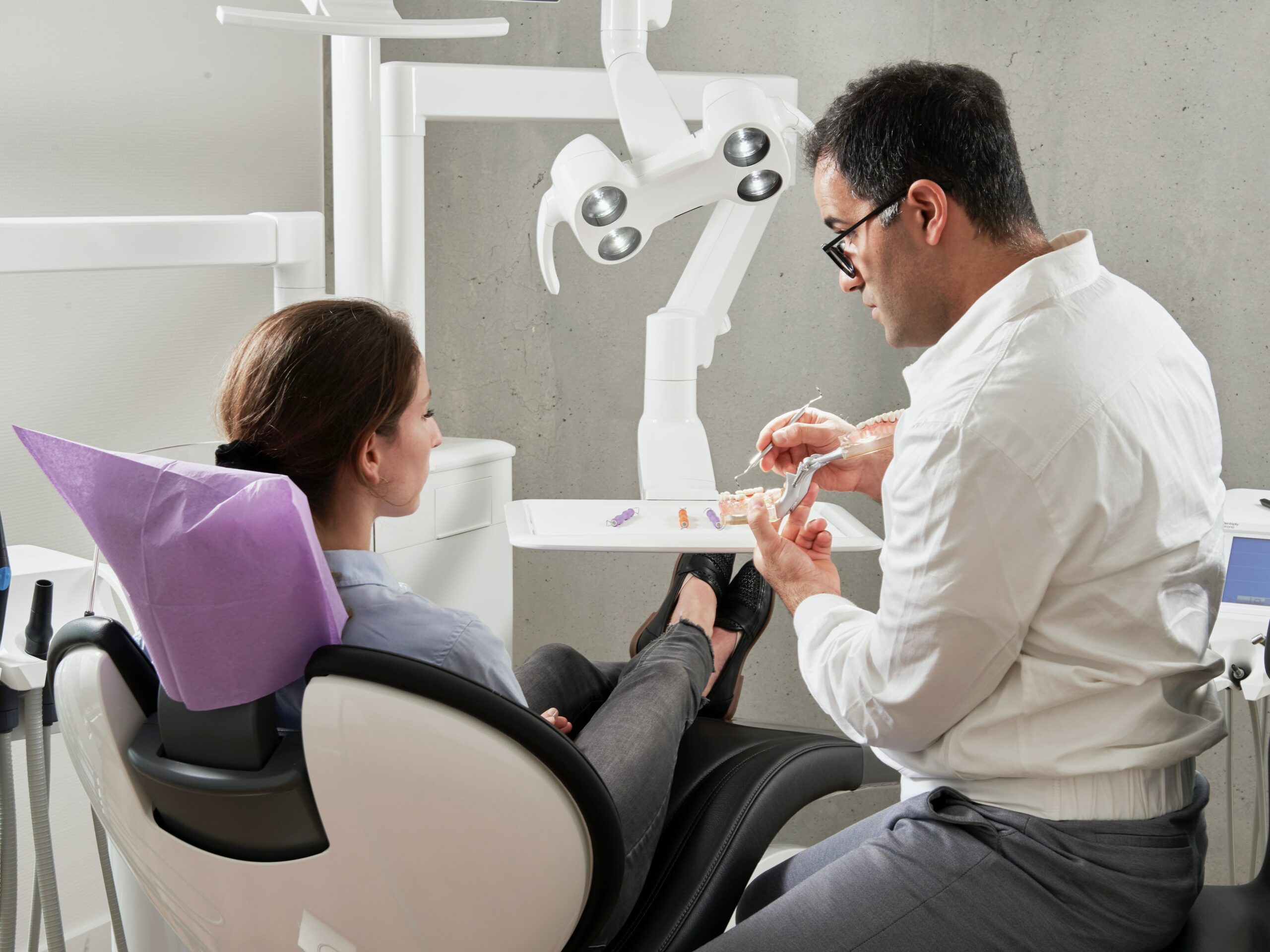 A dentist educating a patient